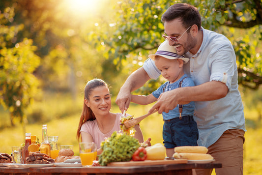 happy family eating organic superfoods in the summer, they are healthy because they take liposomal vitamin D3 and liposomal Vitamin K2